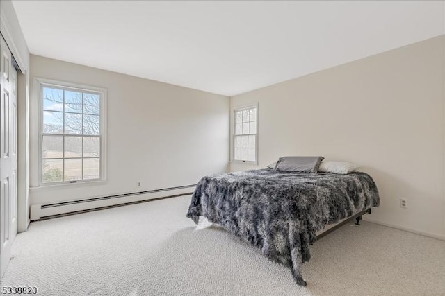 bedroom featuring baseboard heating and carpet