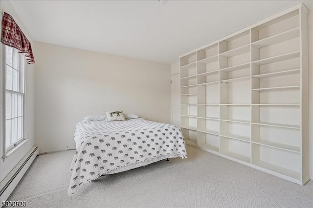 carpeted bedroom with multiple windows and baseboard heating