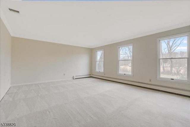 spare room with a baseboard heating unit, baseboards, visible vents, and light colored carpet