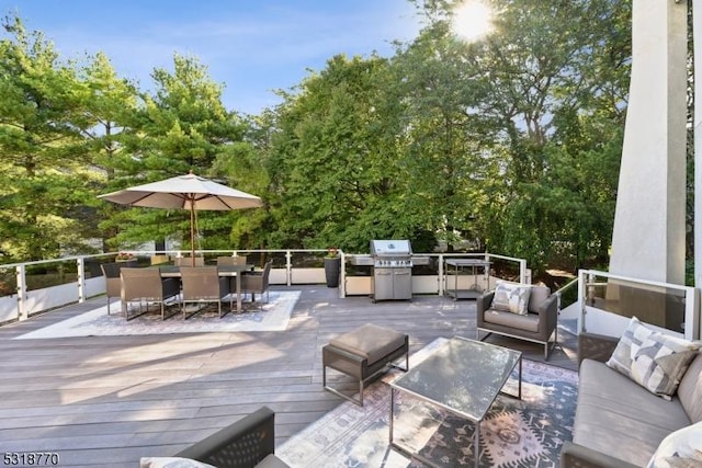 wooden deck with outdoor dining area, area for grilling, and an outdoor hangout area