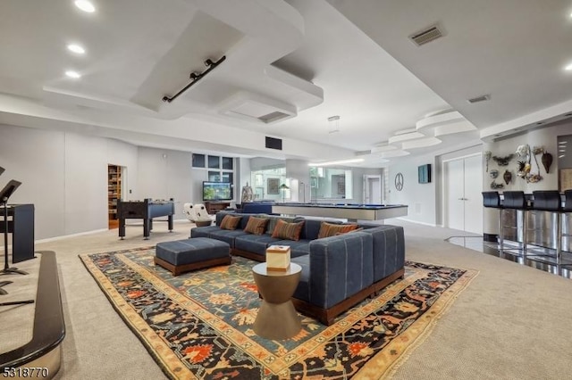 carpeted living area featuring visible vents and recessed lighting