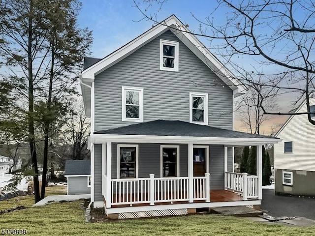 view of front of house with covered porch and a front yard