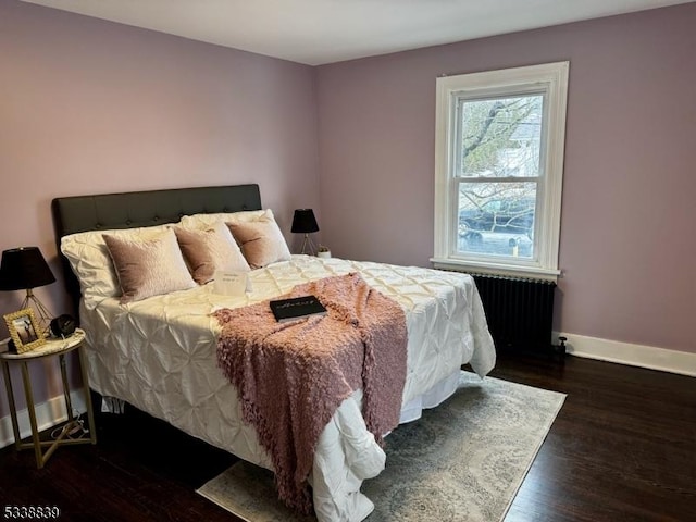 bedroom featuring radiator and dark wood-type flooring