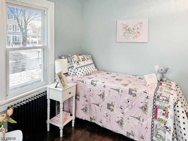 bedroom featuring radiator and dark wood-type flooring