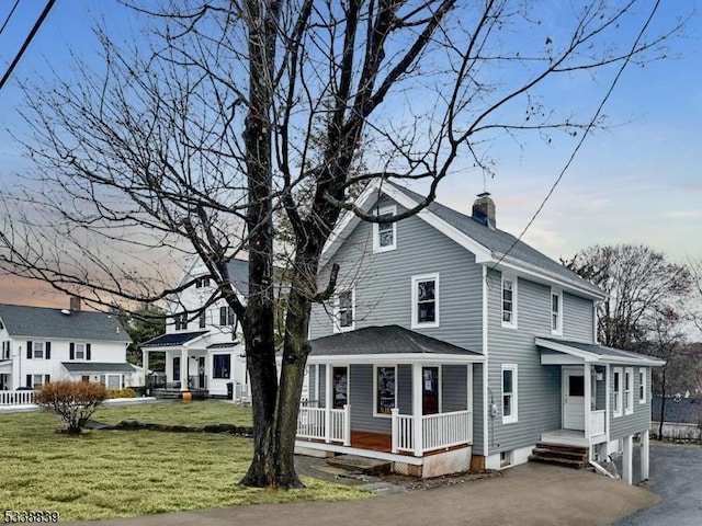 view of front facade with covered porch and a front yard