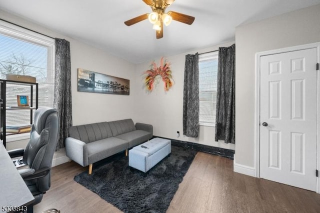 office area with ceiling fan, baseboards, and wood finished floors