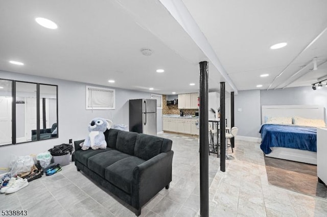 living area with recessed lighting and baseboards