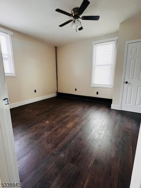 spare room with ceiling fan, baseboards, and hardwood / wood-style floors