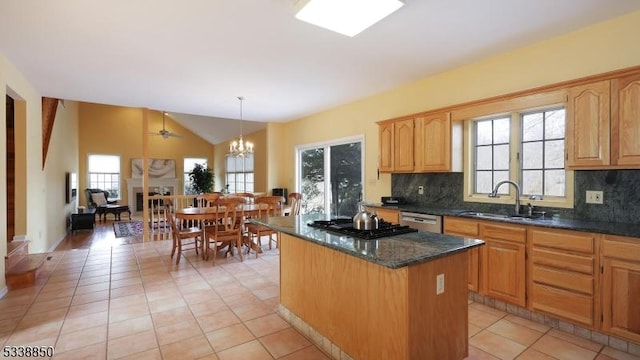 kitchen featuring hanging light fixtures, tasteful backsplash, a kitchen island, and a sink