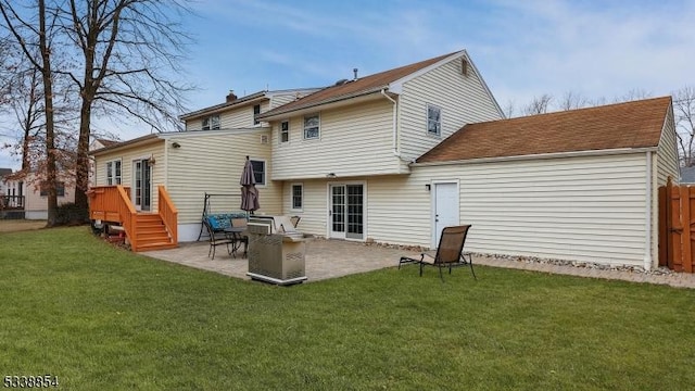 rear view of house featuring a patio area and a yard