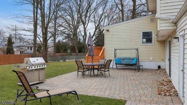 view of patio with a fenced backyard, outdoor dining area, and area for grilling