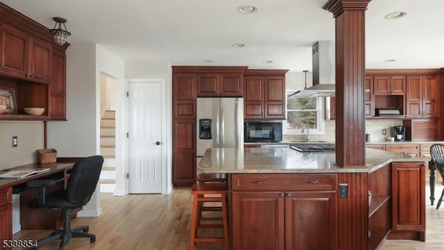 kitchen with light stone counters, a center island, stainless steel fridge, and open shelves