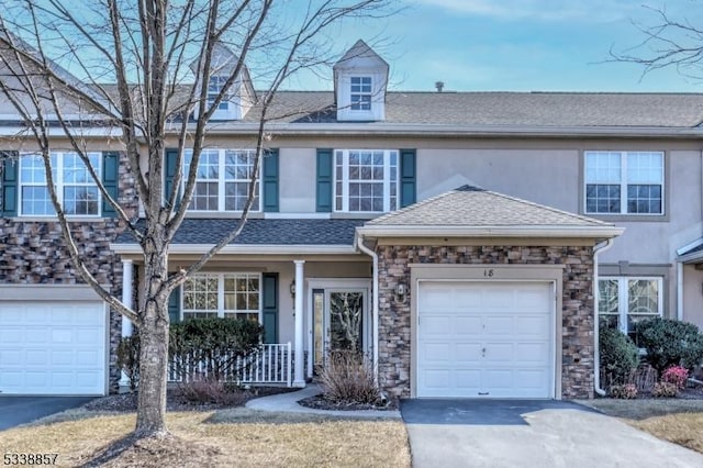 townhome / multi-family property featuring aphalt driveway, stone siding, a shingled roof, and stucco siding