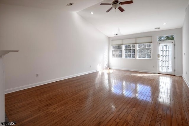 unfurnished living room featuring hardwood / wood-style flooring, baseboards, visible vents, and a ceiling fan