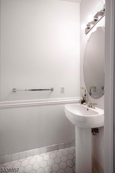 bathroom with a wainscoted wall