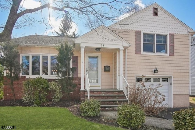 view of front of property with aphalt driveway and an attached garage