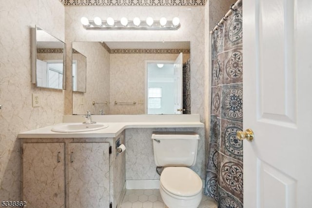 bathroom featuring tile patterned floors, vanity, toilet, and wallpapered walls