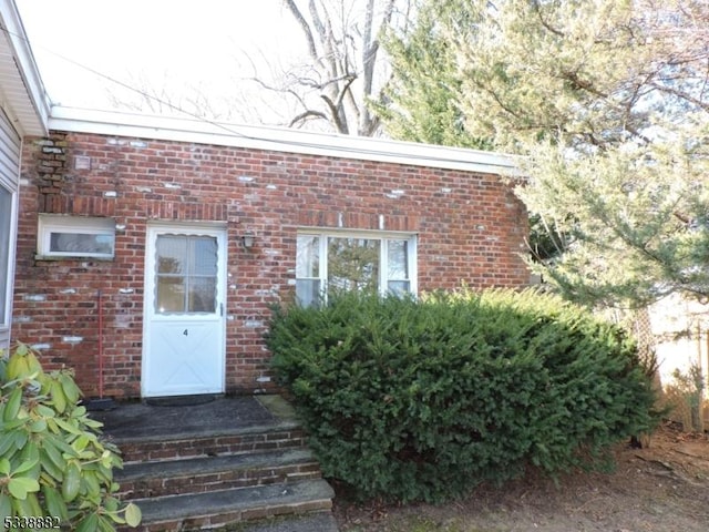 entrance to property with brick siding