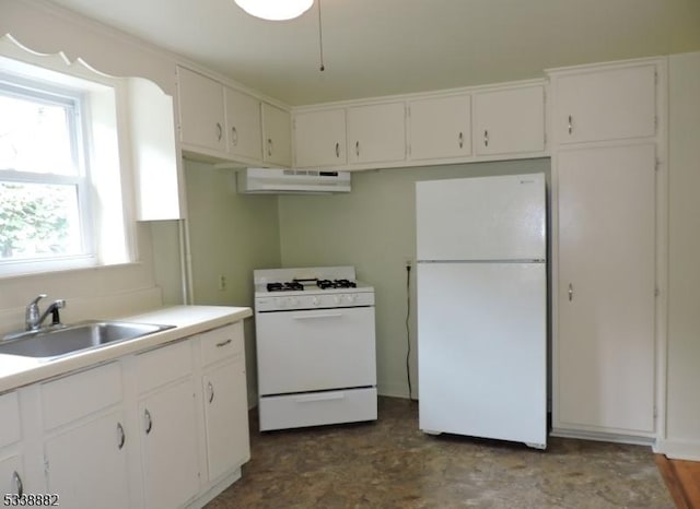 kitchen featuring white appliances, under cabinet range hood, white cabinetry, and a sink