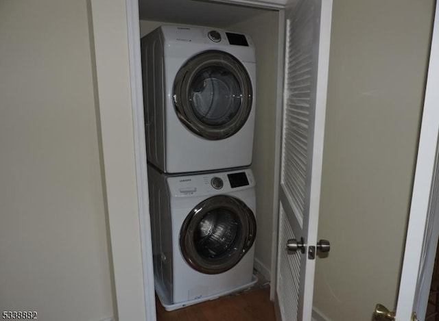 laundry area featuring stacked washing maching and dryer and laundry area