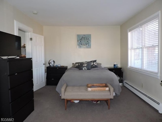 carpeted bedroom with a baseboard heating unit