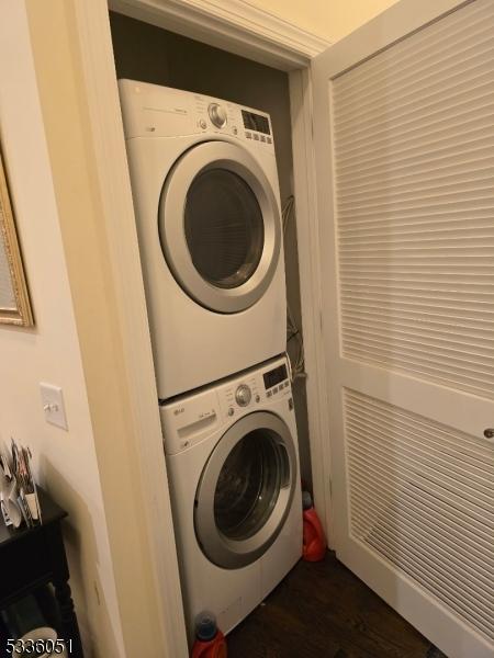 washroom featuring laundry area and stacked washer and clothes dryer