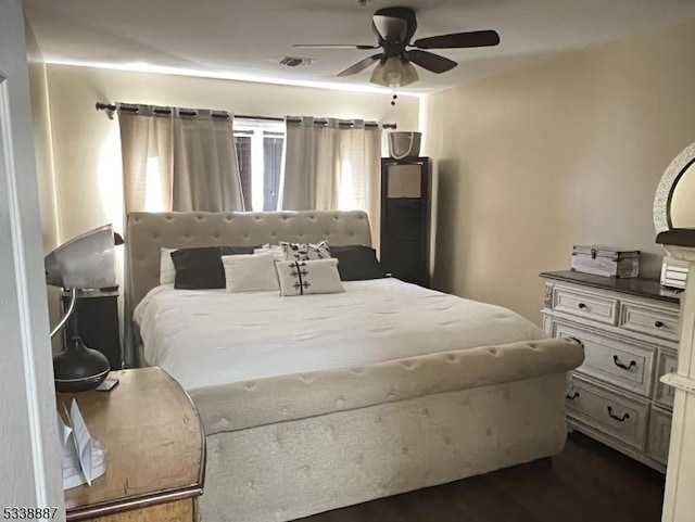 bedroom with dark wood-type flooring and ceiling fan