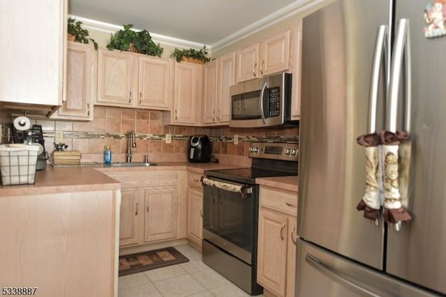 kitchen with appliances with stainless steel finishes, sink, crown molding, and light brown cabinetry