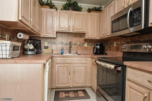 kitchen featuring stainless steel appliances, backsplash, and light brown cabinetry