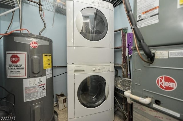 washroom with electric water heater and stacked washer and dryer