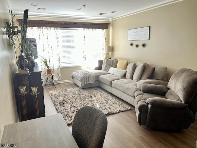 living room with ornamental molding and hardwood / wood-style floors