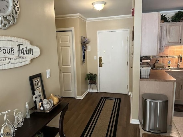 interior space featuring sink, crown molding, and hardwood / wood-style floors