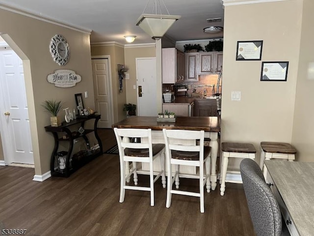 dining space featuring crown molding and dark hardwood / wood-style flooring