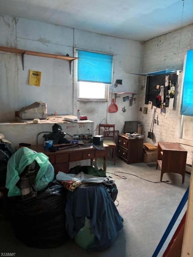 miscellaneous room featuring unfinished concrete floors and a workshop area