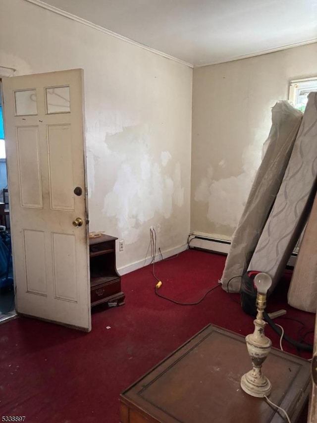 empty room featuring baseboards and a baseboard heating unit