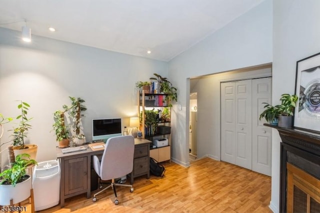 home office featuring vaulted ceiling, light wood finished floors, and recessed lighting