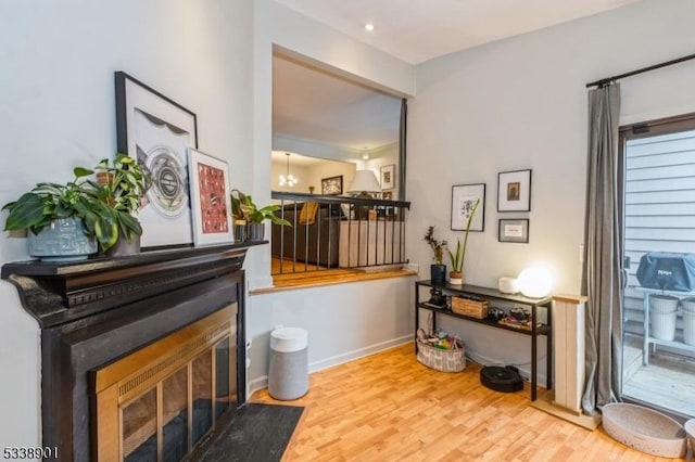 interior space with a notable chandelier, baseboards, and wood finished floors