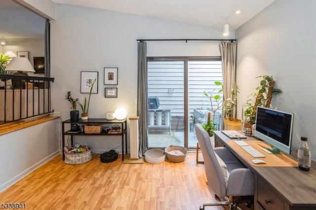 office area featuring light wood-style floors, lofted ceiling, and baseboards