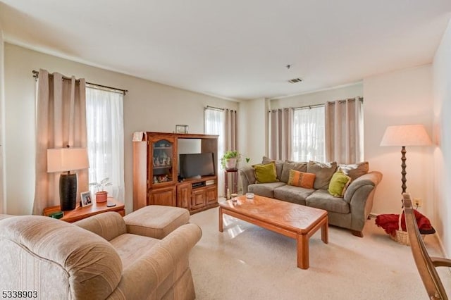 living room with visible vents and light colored carpet