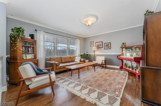 living area with crown molding and hardwood / wood-style floors