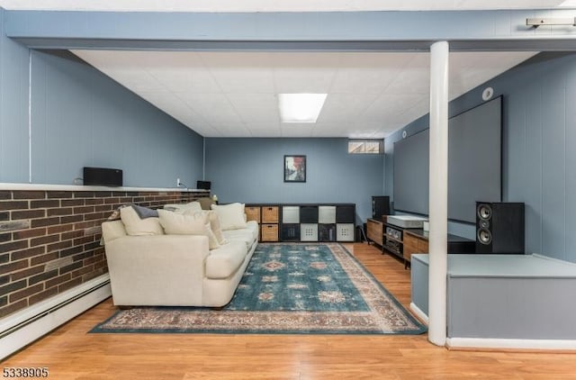 living room featuring a baseboard heating unit and wood-type flooring