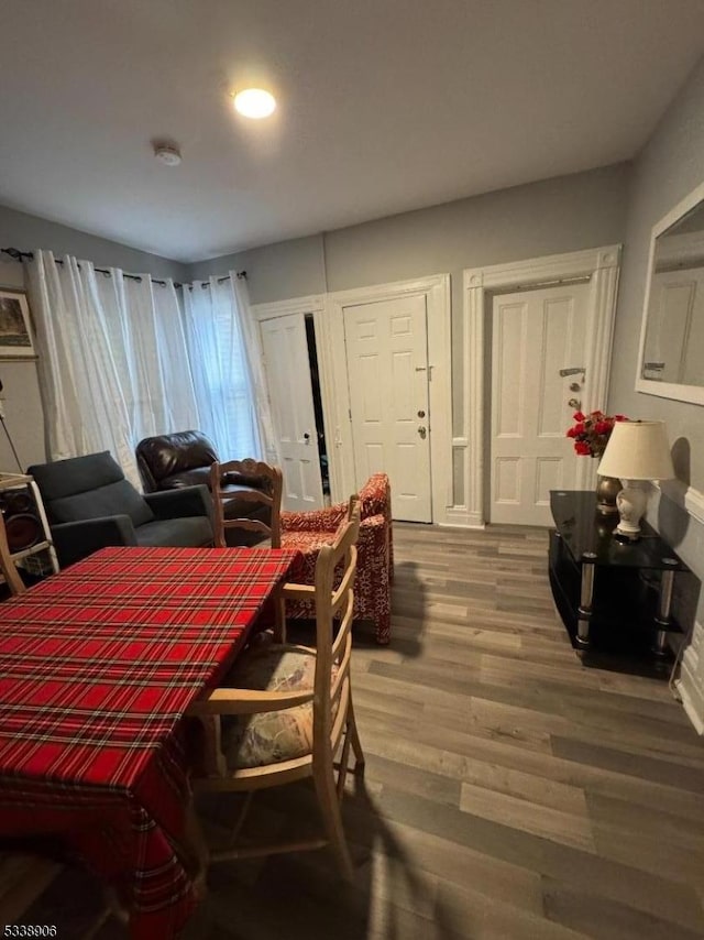 dining space with wood finished floors