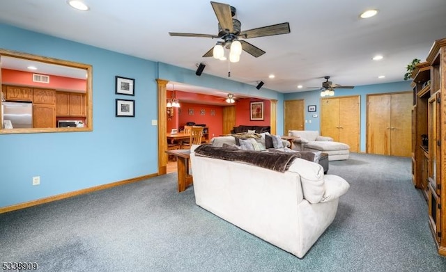 living room featuring ceiling fan and carpet flooring