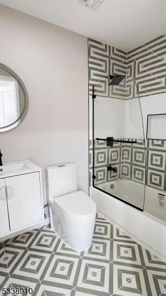 full bathroom with toilet, vanity, tile patterned flooring, and enclosed tub / shower combo