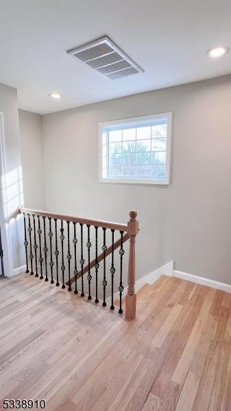 stairway with hardwood / wood-style floors