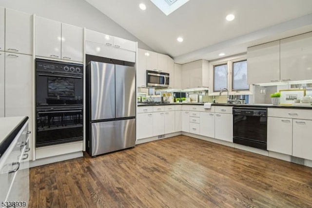 kitchen featuring white cabinets, lofted ceiling with skylight, black appliances, and dark hardwood / wood-style floors