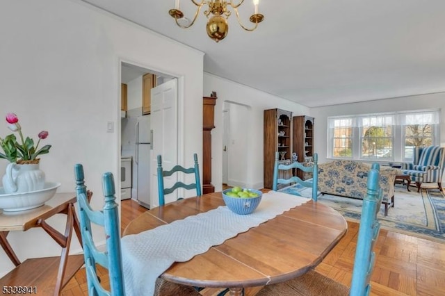 dining area featuring light parquet flooring and a chandelier