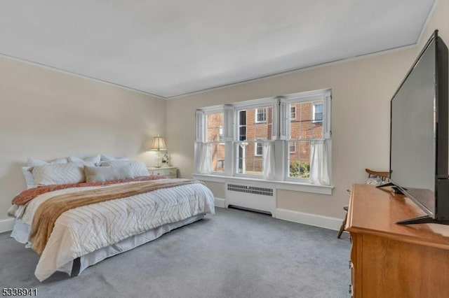 bedroom with carpet, radiator, and ornamental molding