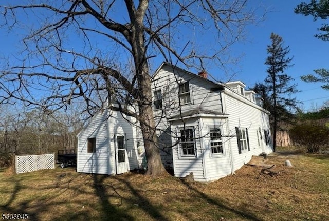 view of side of property with a lawn