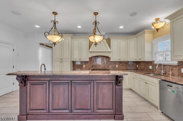 kitchen with cream cabinetry, decorative light fixtures, a kitchen island, and stainless steel dishwasher